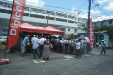 People gather in lines in front of Digicel boothes in Roseau Dominica.jpg